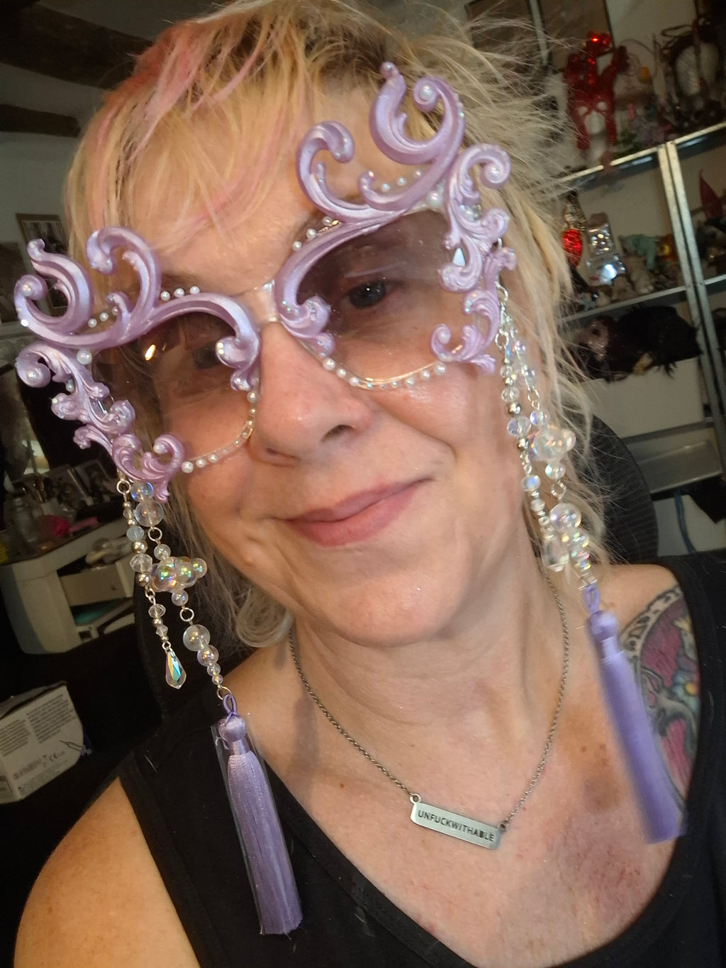 Hand-sculpted sunglasses in soft lavender scrollwork with opalescent pearls and lilac tassels.
