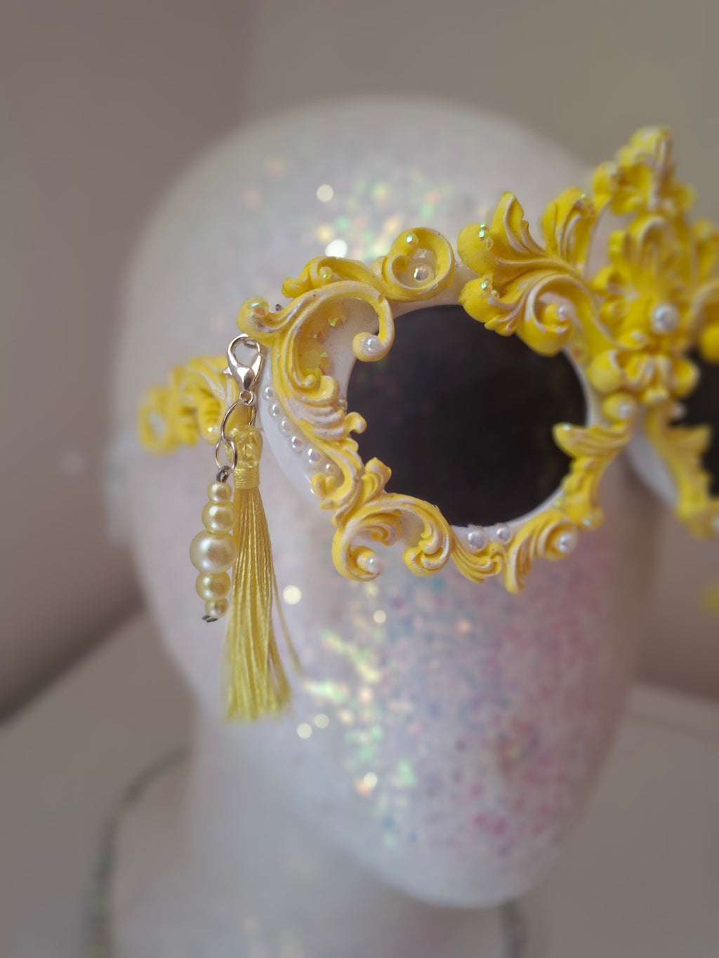  Hand-sculpted sunglasses in gold scrollwork with pearls and tassel drops. 