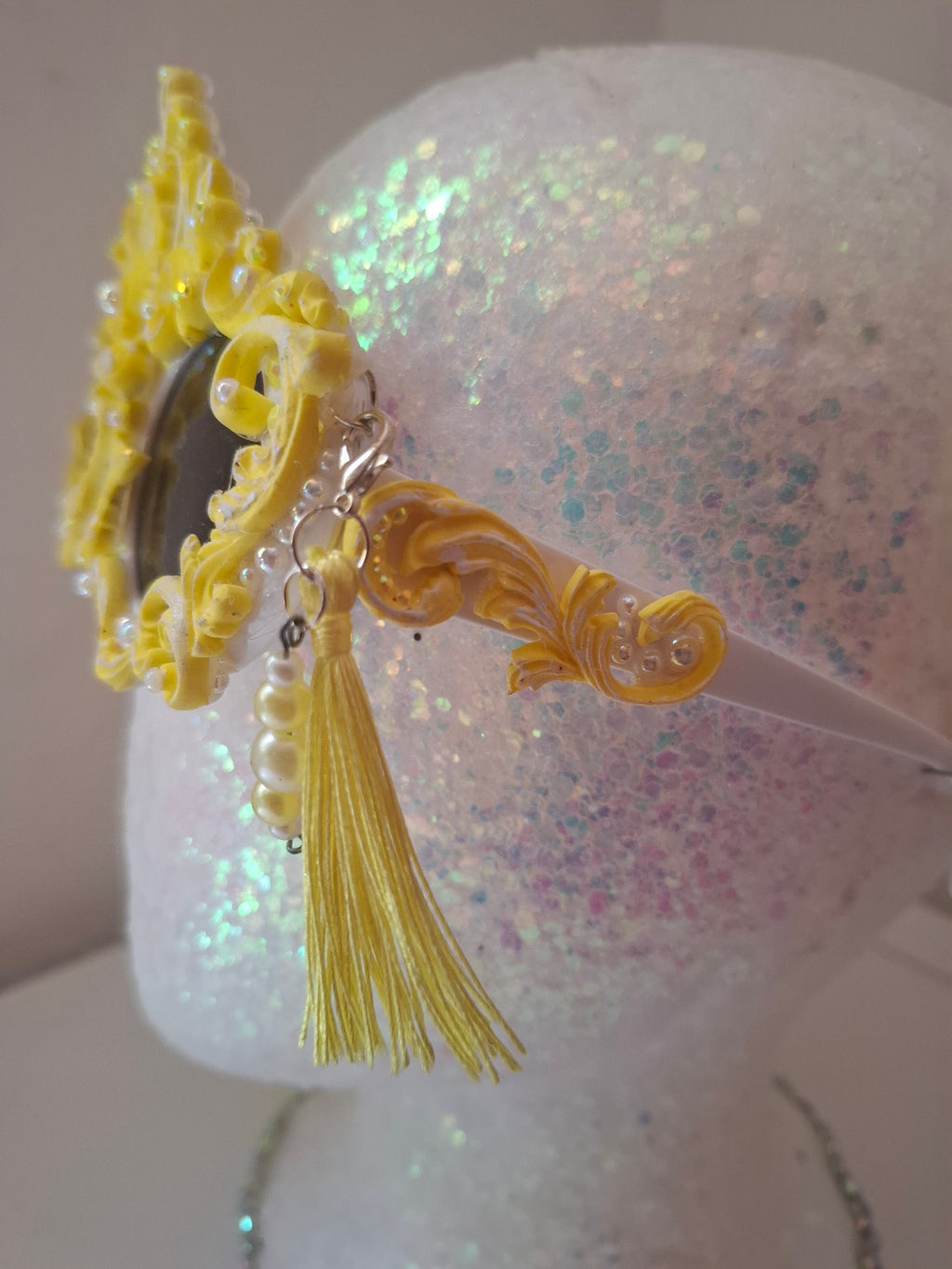  Hand-sculpted sunglasses in gold scrollwork with pearls and tassel drops. 