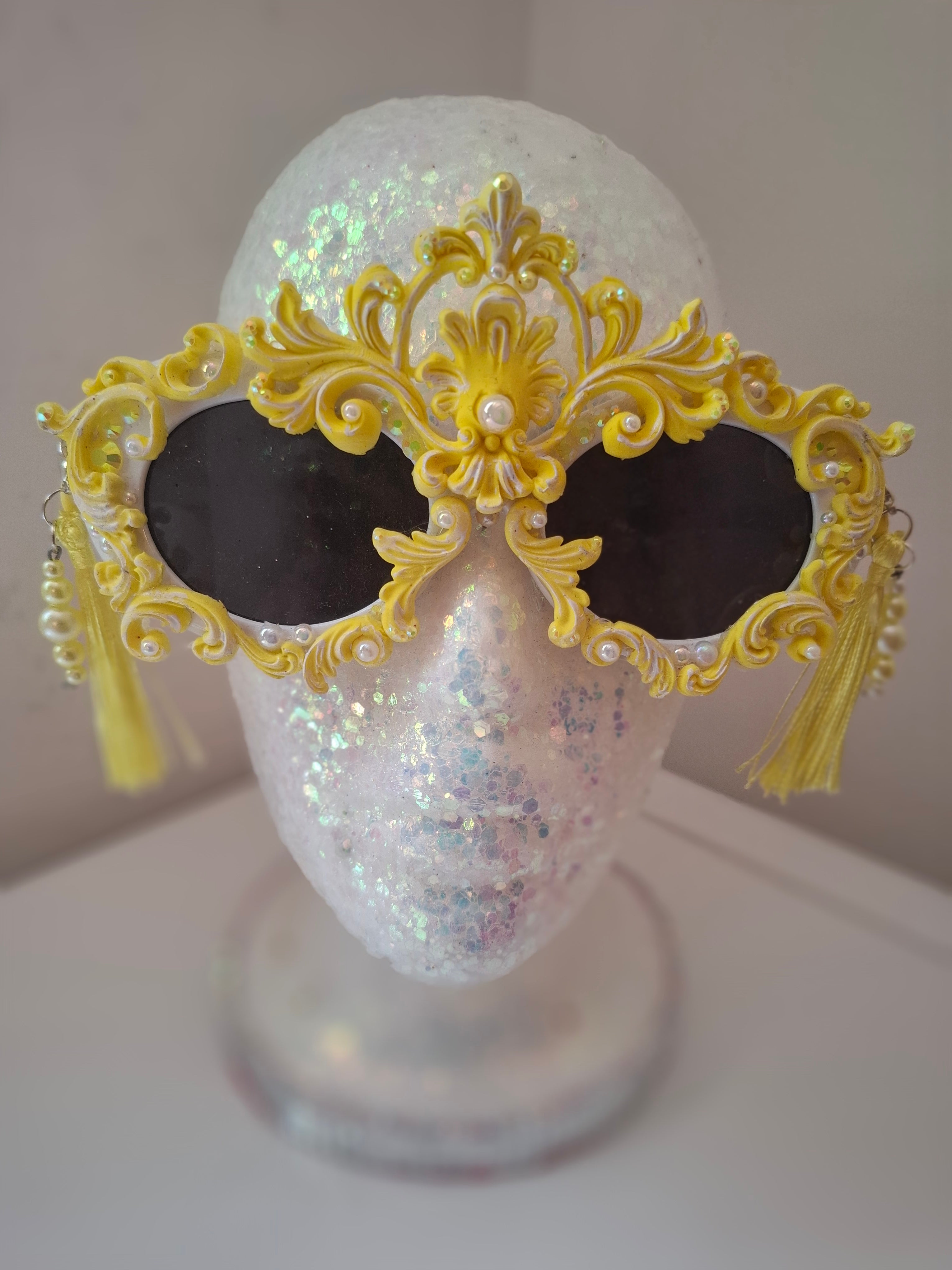  Hand-sculpted sunglasses in gold scrollwork with pearls and tassel drops. 