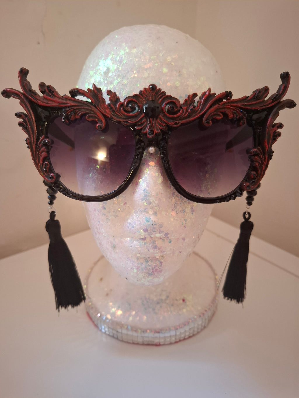 Hand-sculpted sunglasses with crimson scrollwork detail