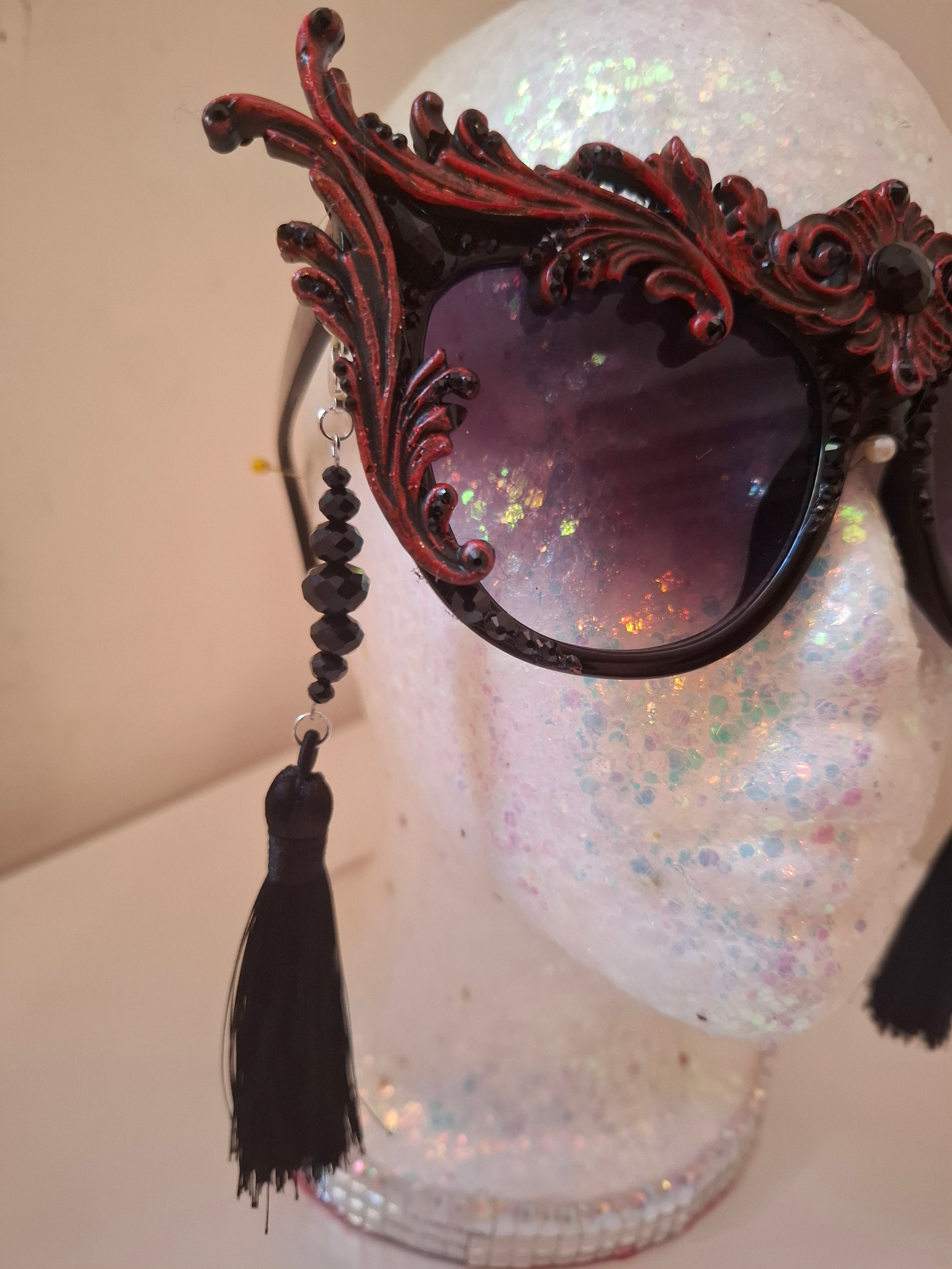 Hand-sculpted sunglasses with crimson scrollwork detail