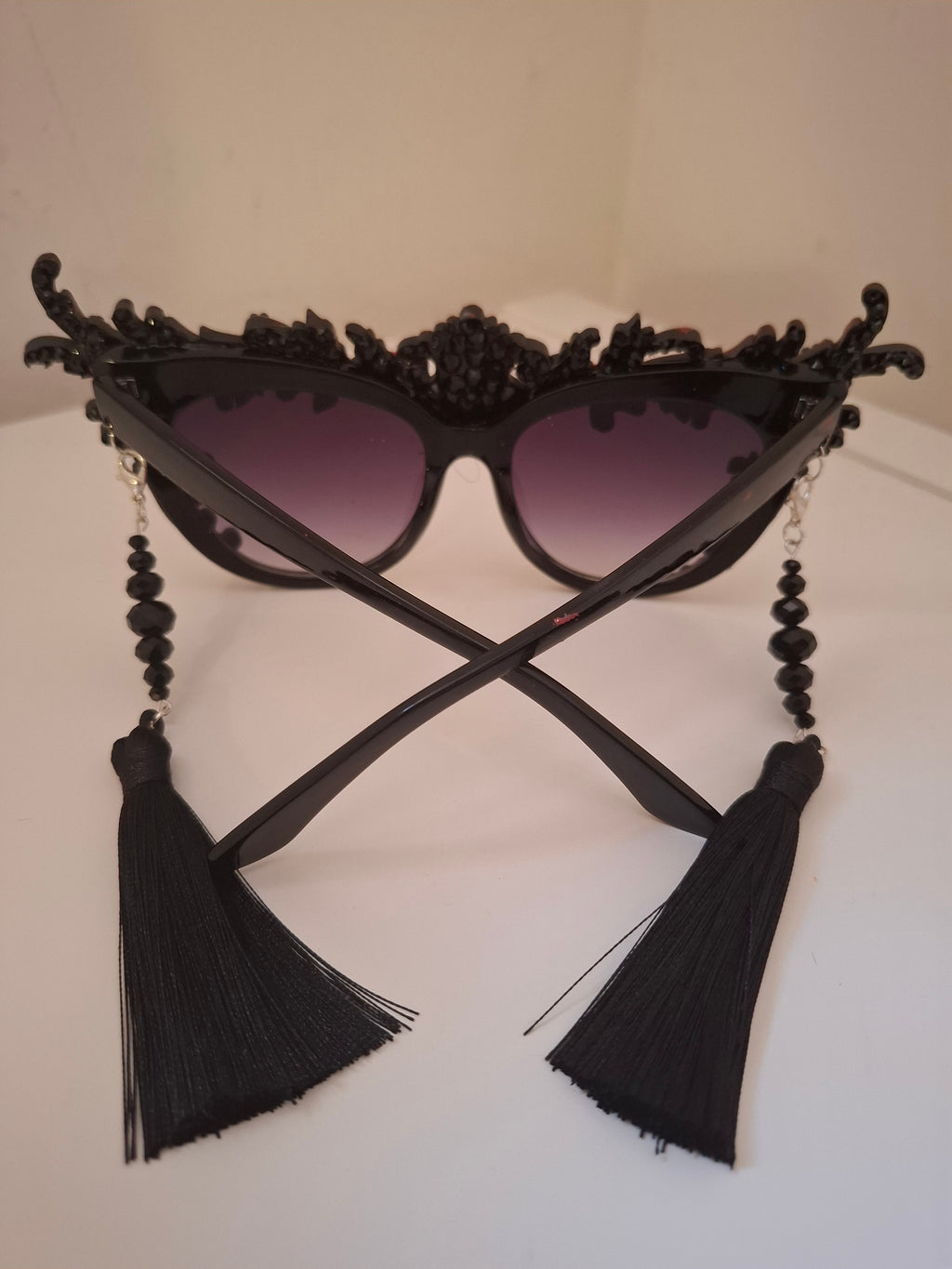 Hand-sculpted sunglasses with crimson scrollwork detail