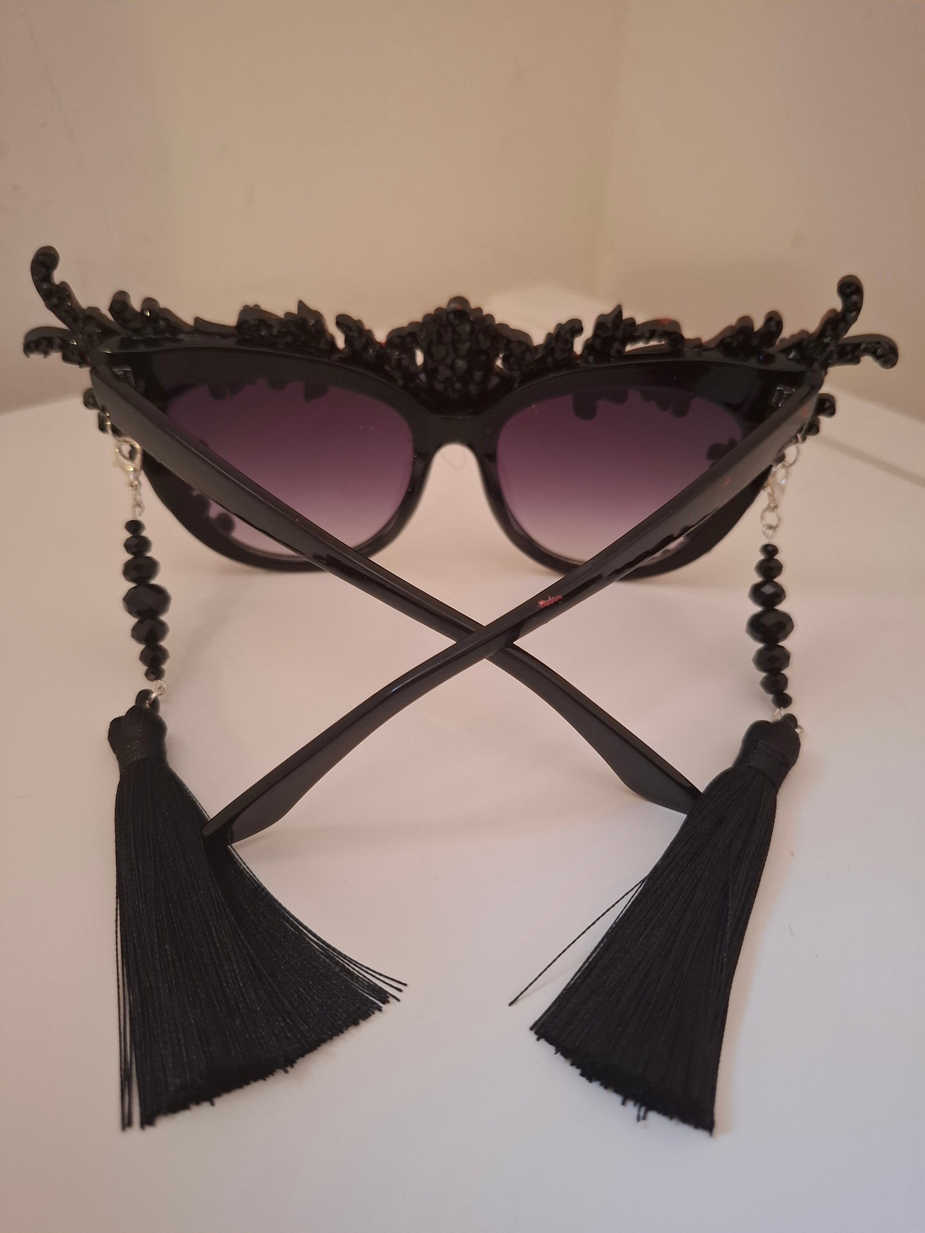 Hand-sculpted sunglasses with crimson scrollwork detail