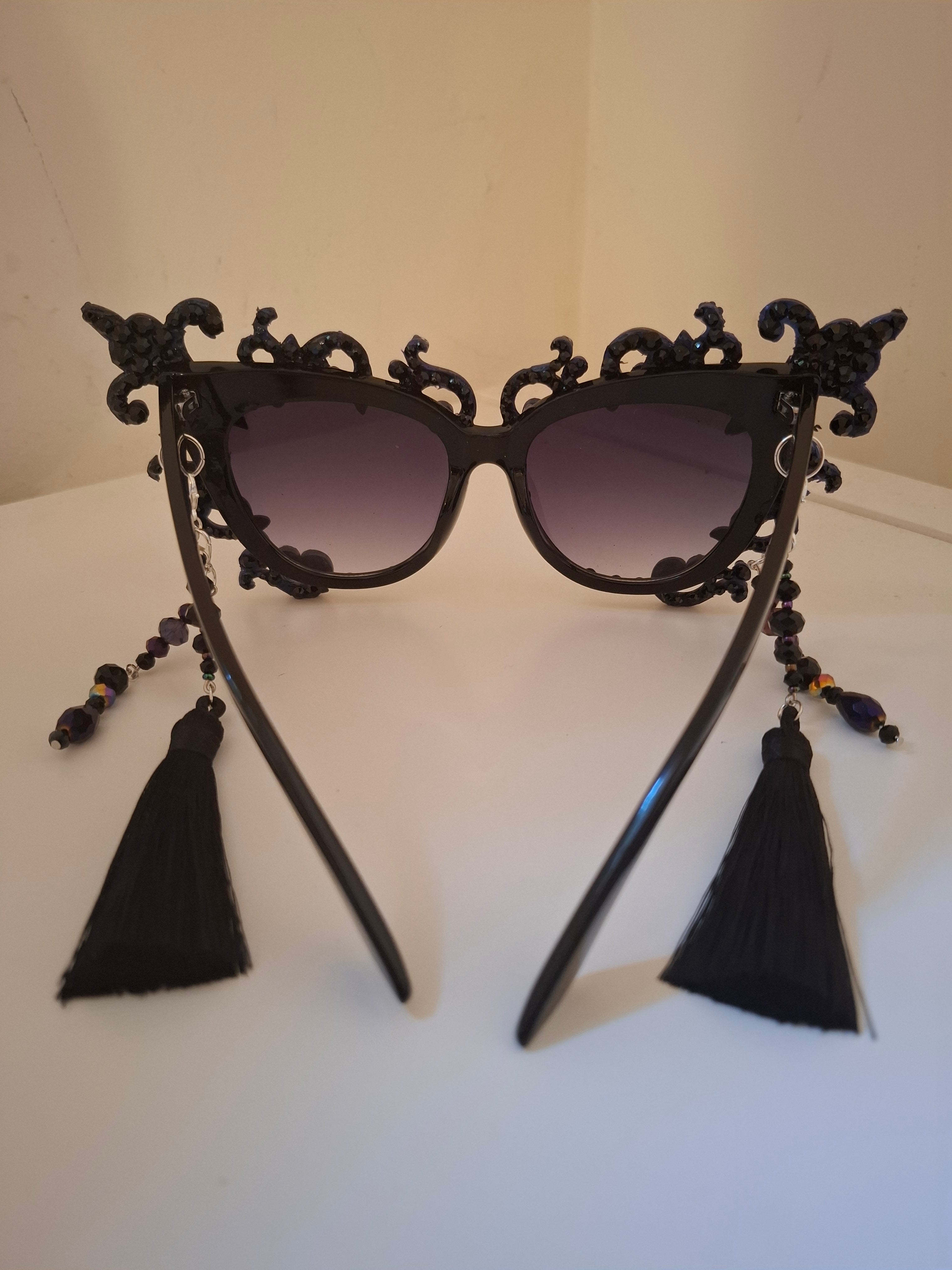 Hand-sculpted sunglasses with smoke-swirl scrollwork detail