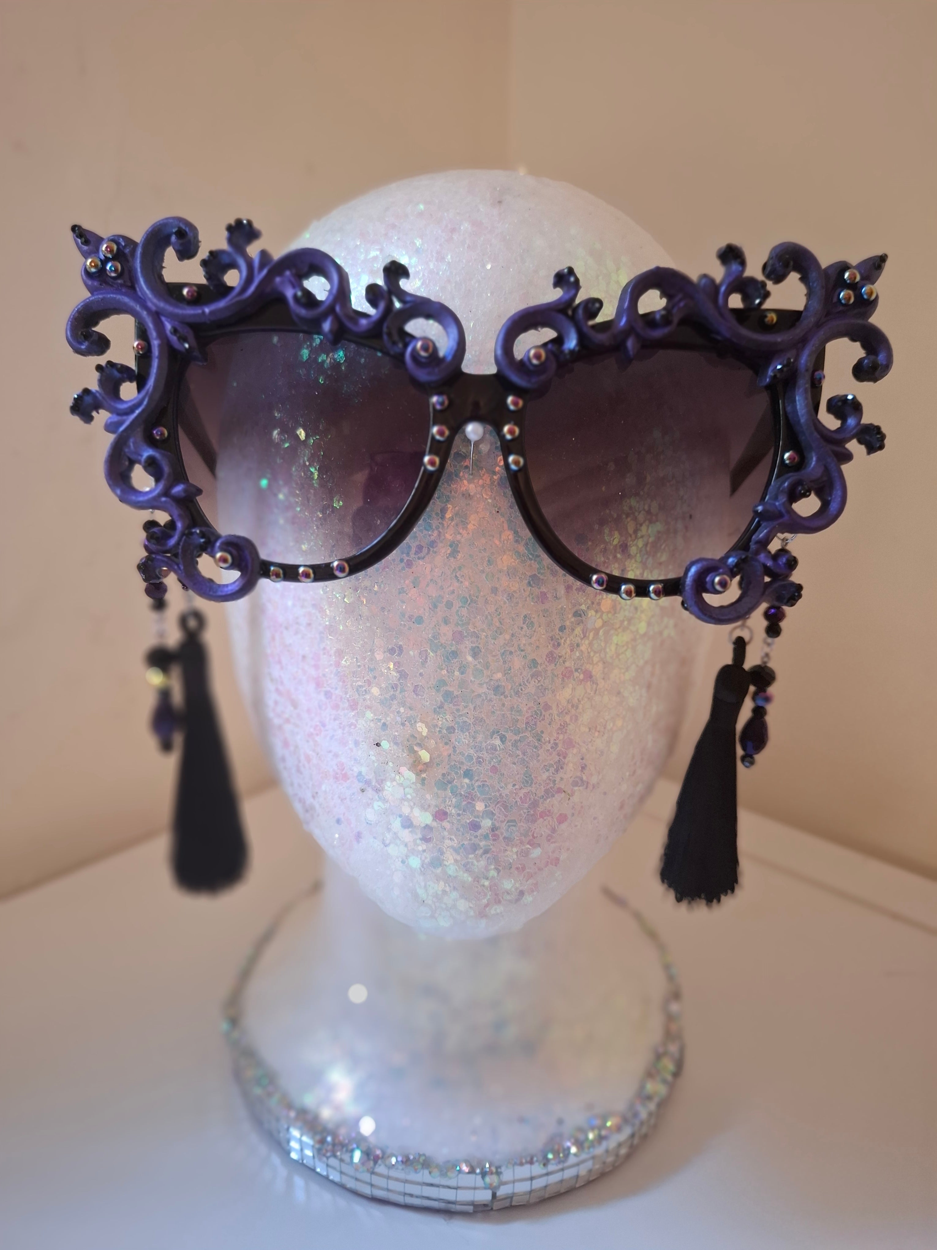 Hand-sculpted sunglasses with smoke-swirl scrollwork detail