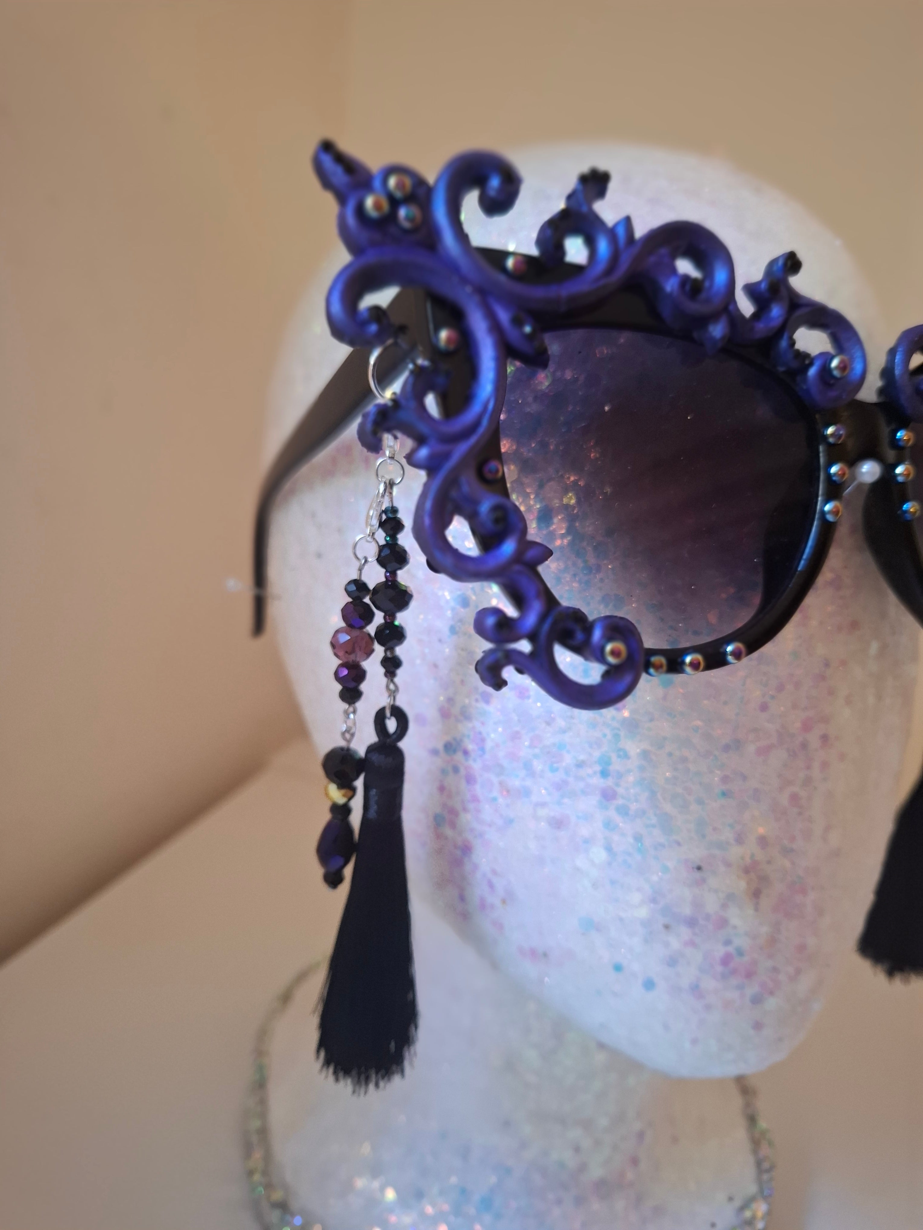 Hand-sculpted sunglasses with smoke-swirl scrollwork detail