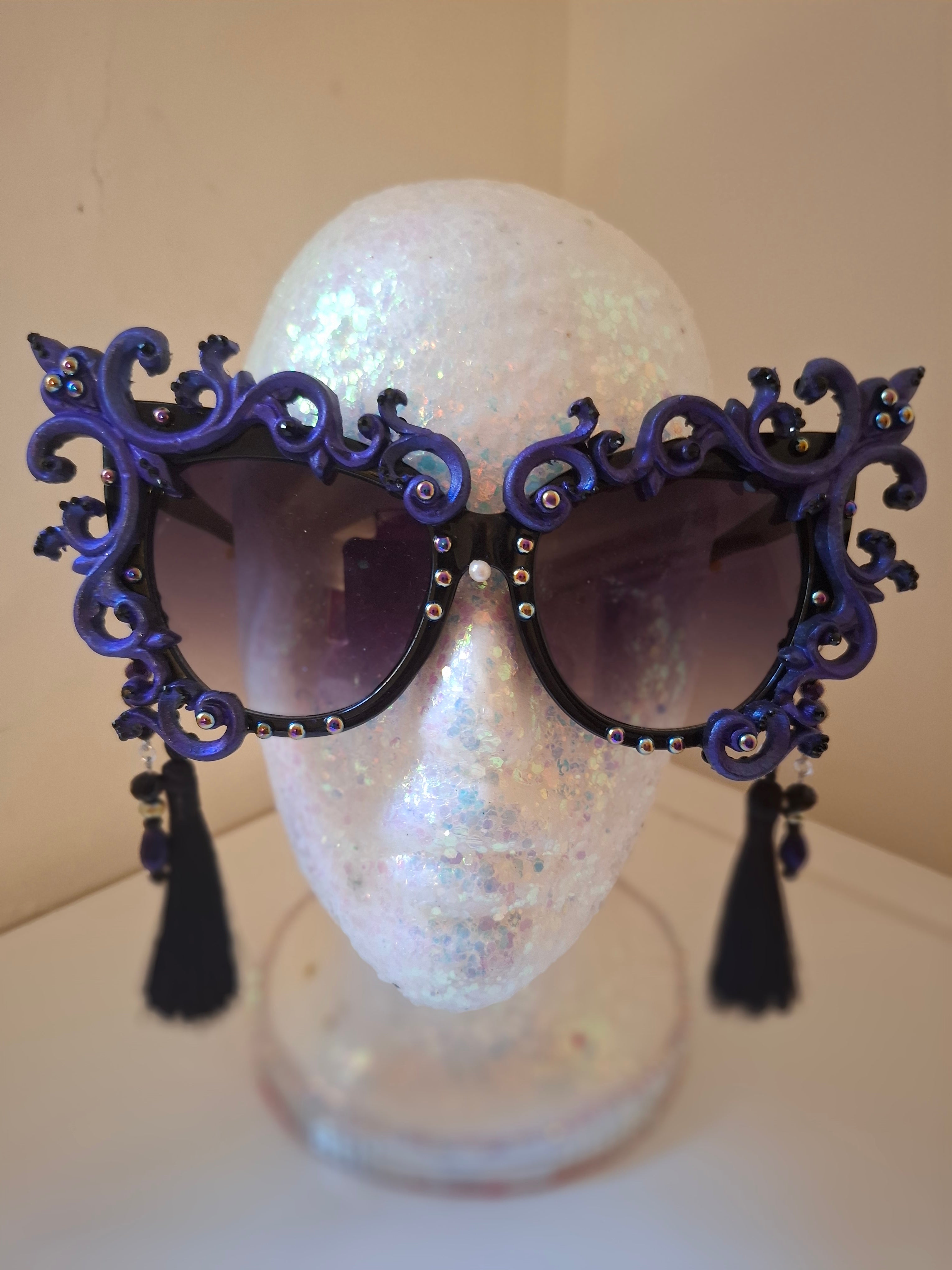 Hand-sculpted sunglasses with smoke-swirl scrollwork detail