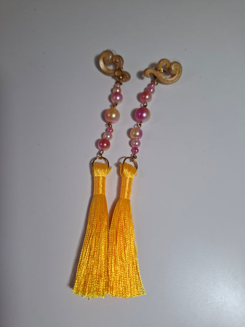 Hand-sculpted resin earrings with beading and tassels, matching the Aurelys sunglasses.