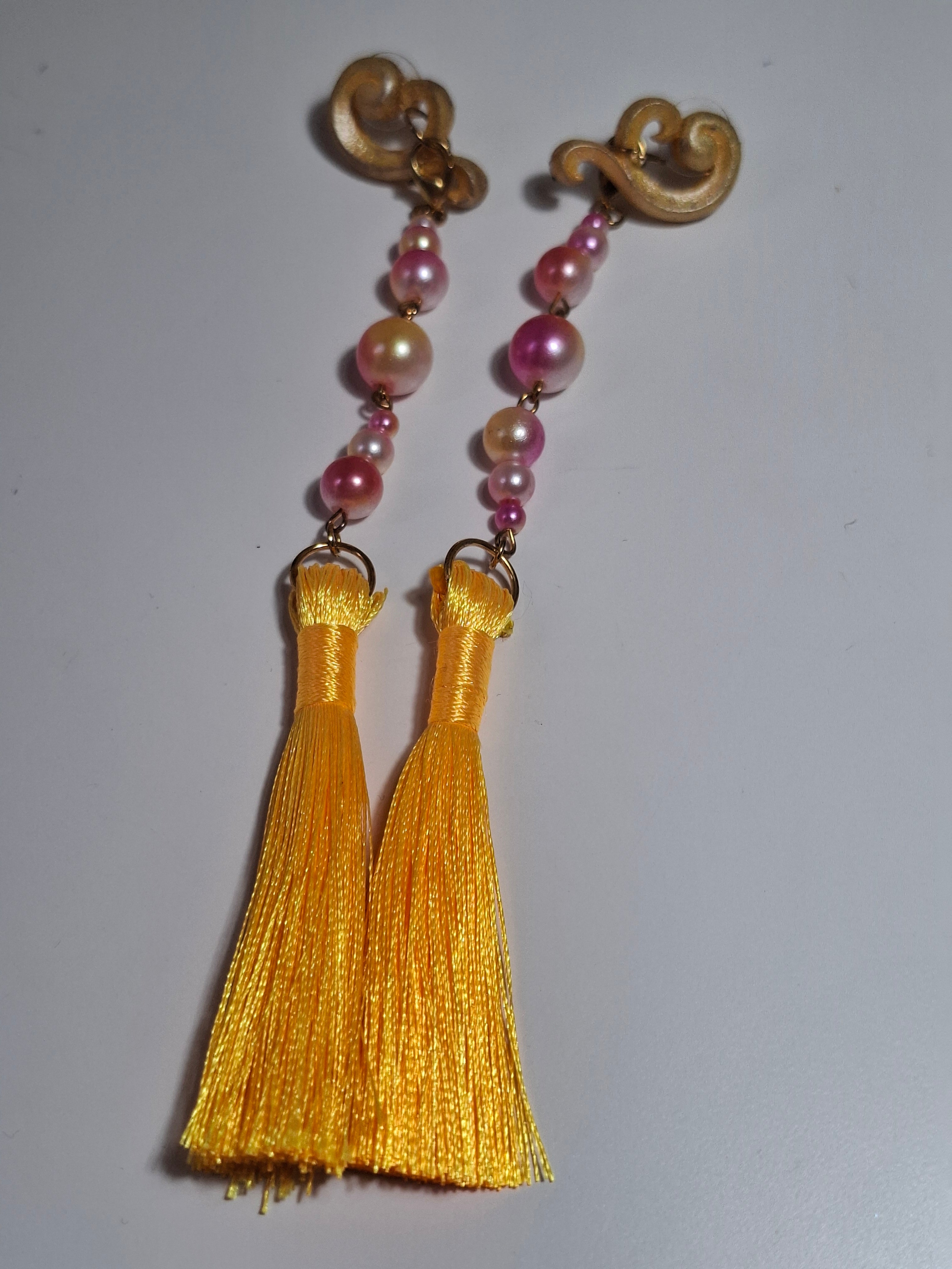 Hand-sculpted resin earrings with beading and tassels, matching the Aurelys sunglasses.