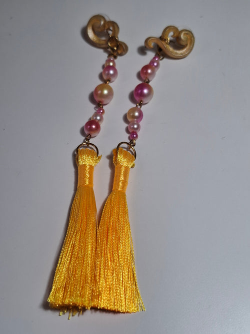 Hand-sculpted resin earrings with beading and tassels, matching the Aurelys sunglasses.