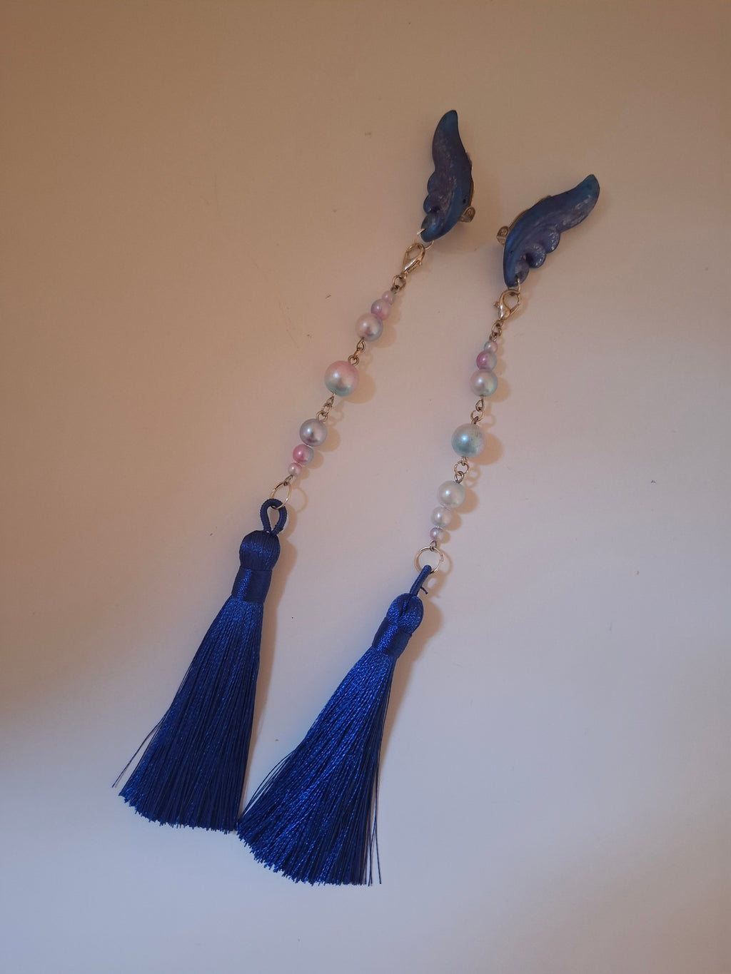 Hand-sculpted resin earrings with beading and tassels