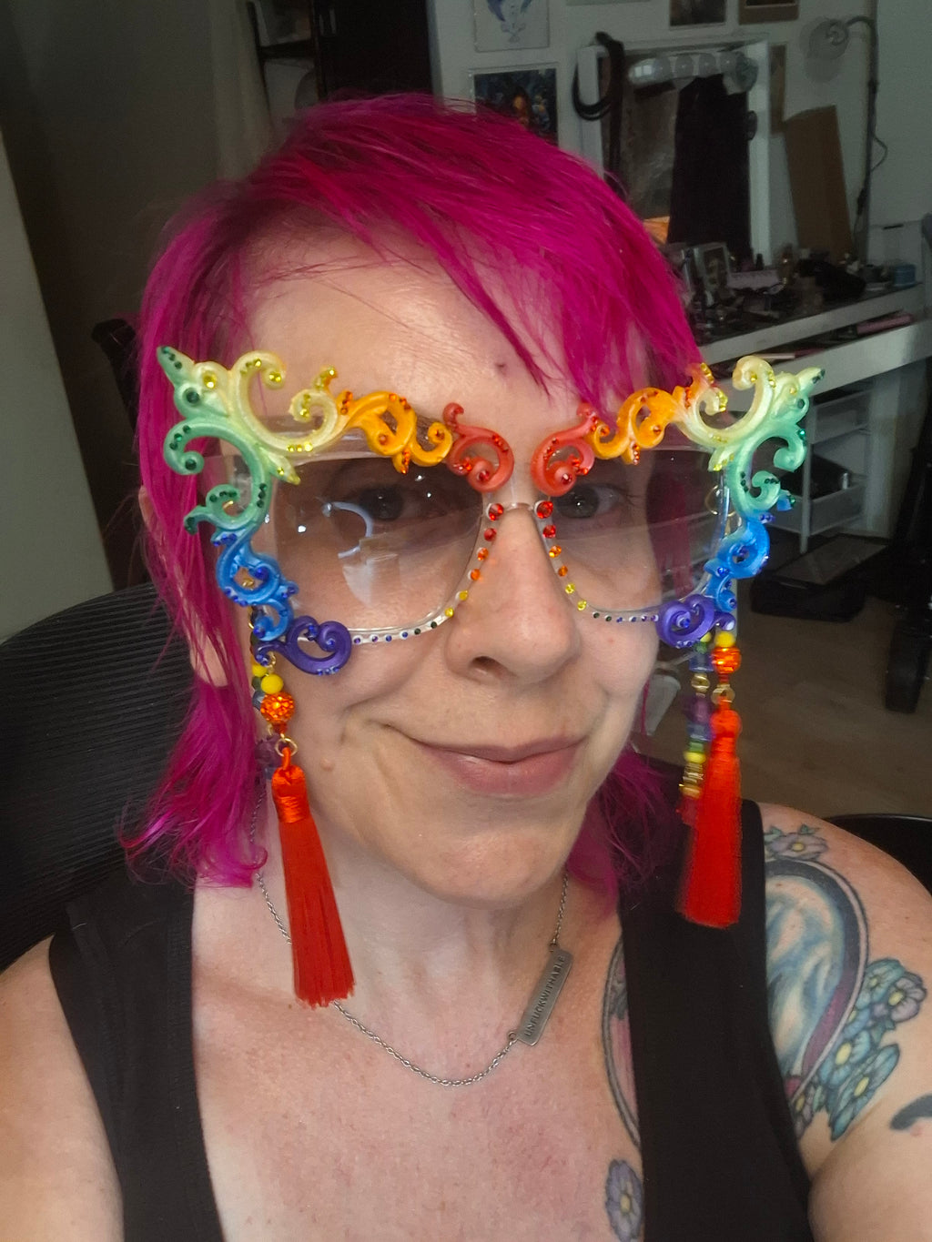 Hand-sculpted Pride sunglasses in classic rainbow flag colors, with red beaded tassels.
