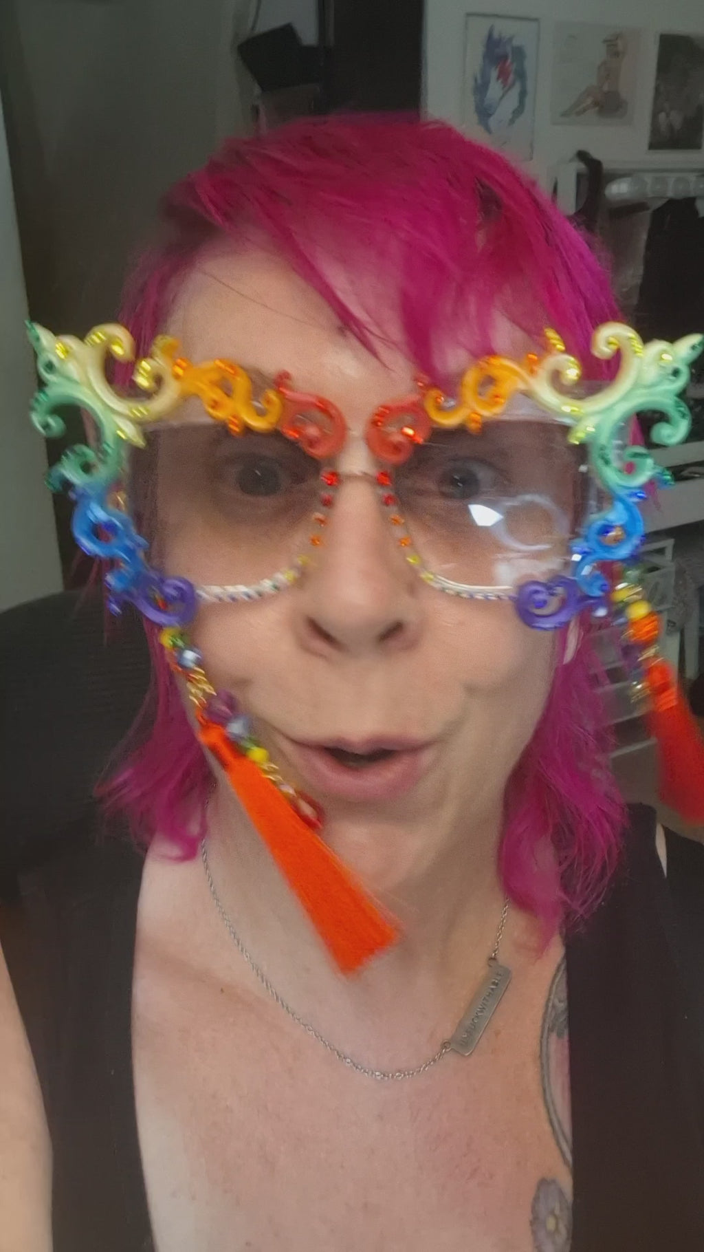 Hand-sculpted Pride sunglasses in classic rainbow flag colors, with red beaded tassels.
