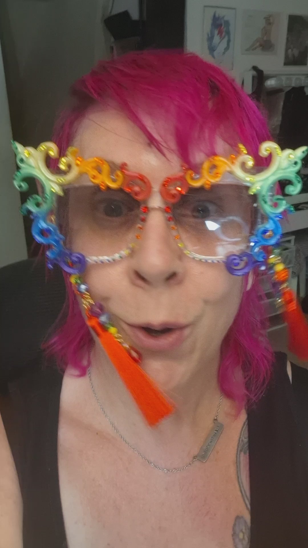 Hand-sculpted Pride sunglasses in classic rainbow flag colors, with red beaded tassels.
